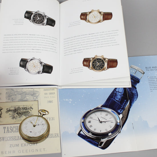 Eterna watches and history brochures open full of wristwatch images